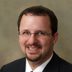 Smiling bespectacled man in suit portrait