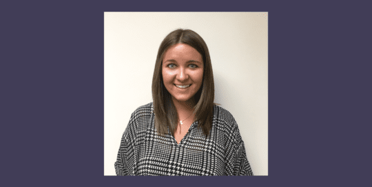 Headshot of a girl wearing a grey top and smiling_Sally