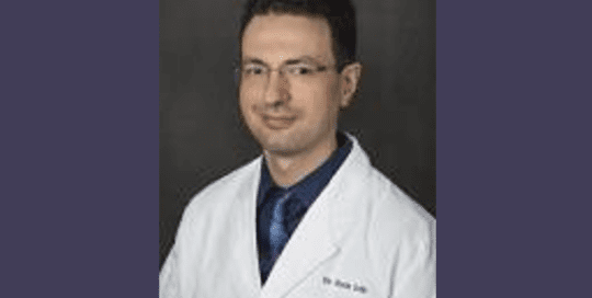 Headshot Photo of a Man Wearing a White Coat_BorrisIoffe