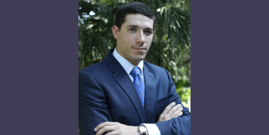 Headshot photo of a man in a blue suit_MichaelFinkelstein