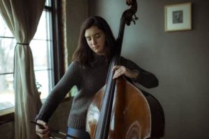 a girl playing the double bass musical instrument