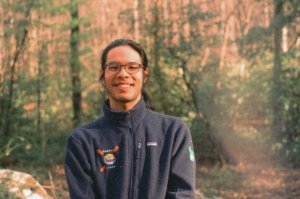 Headshot photo of a man wearing a jacket