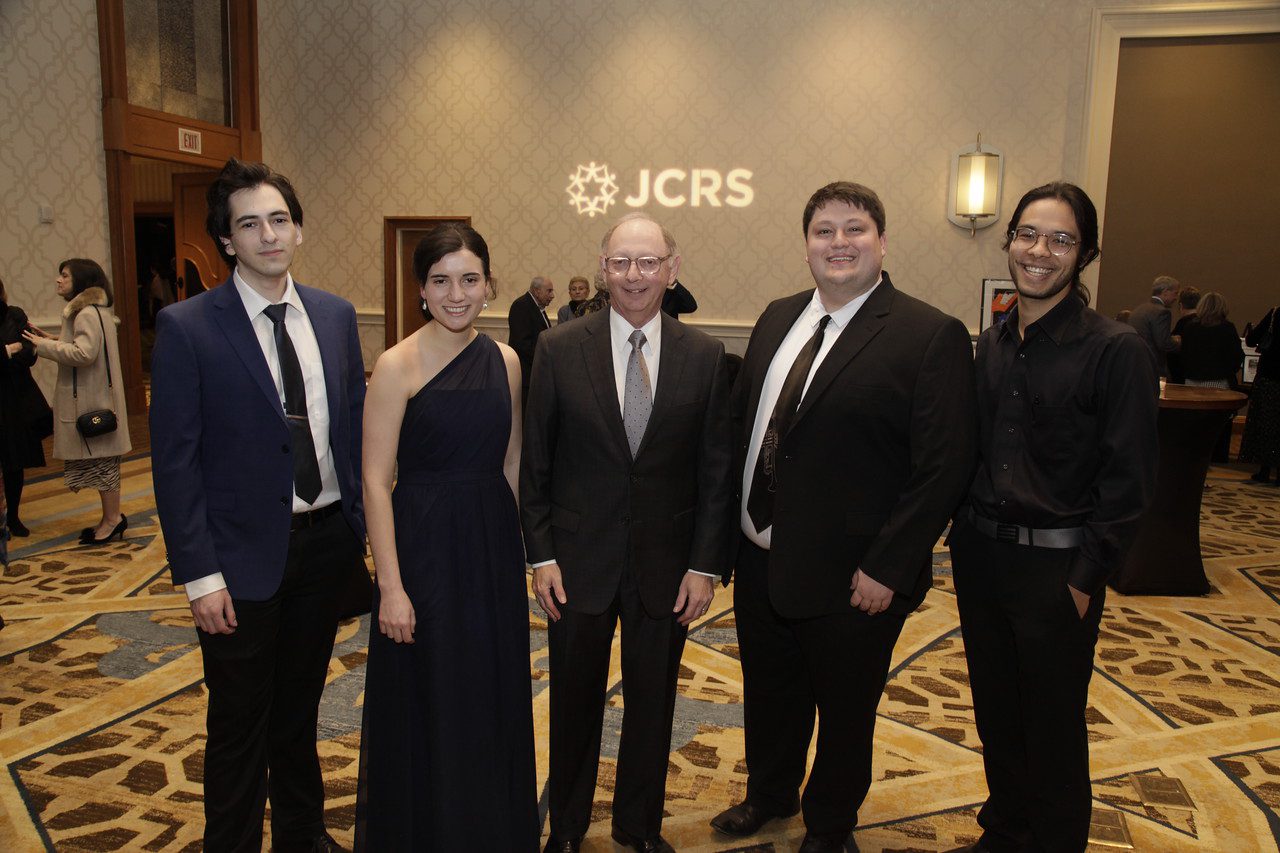 A group of people in black attire at the JCRS event_